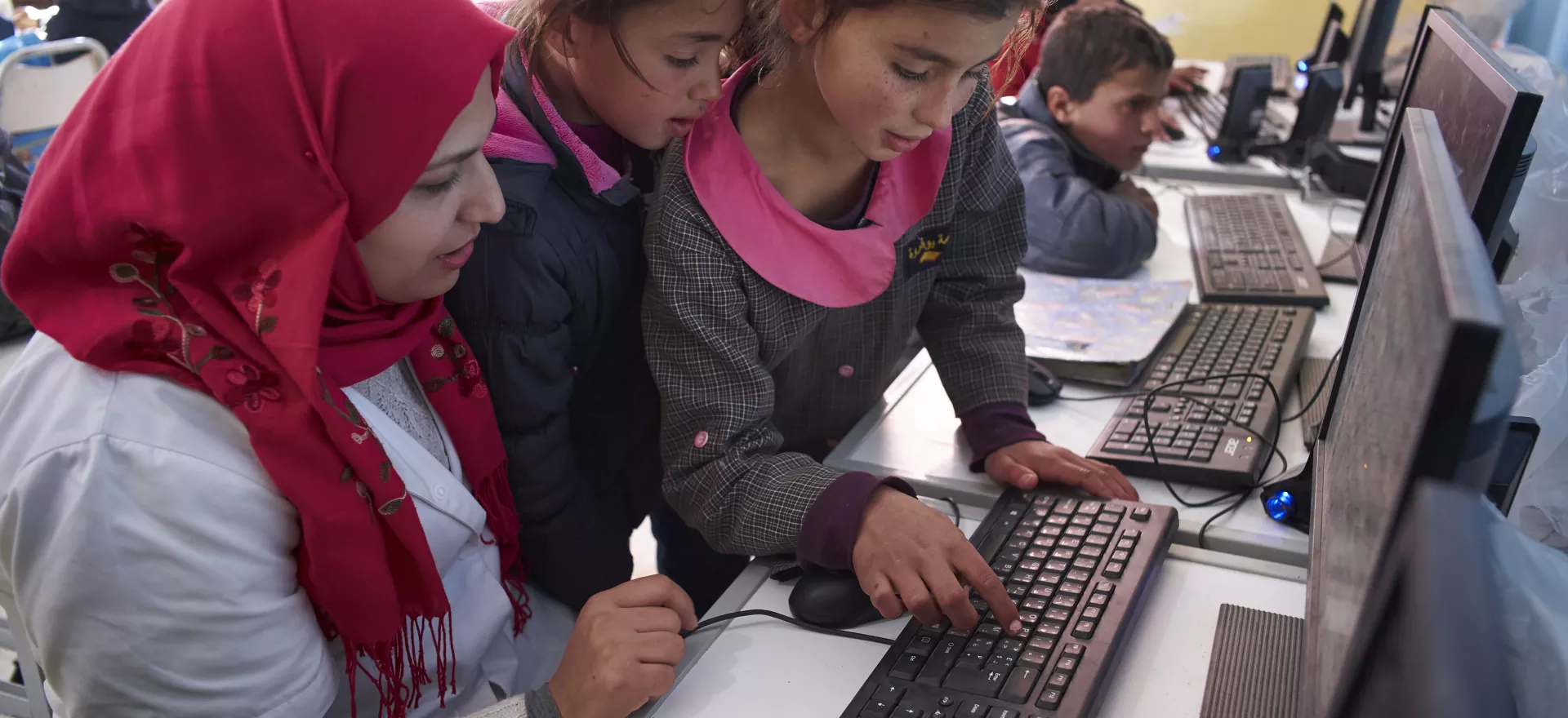 Kids with teacher on computer