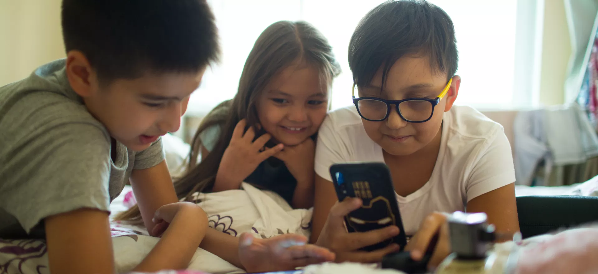 Kids perusing mobile phone