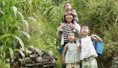 Zhang Qin takes her grandchildren to their family farm nestled on a hill in Guizhou Province, China.