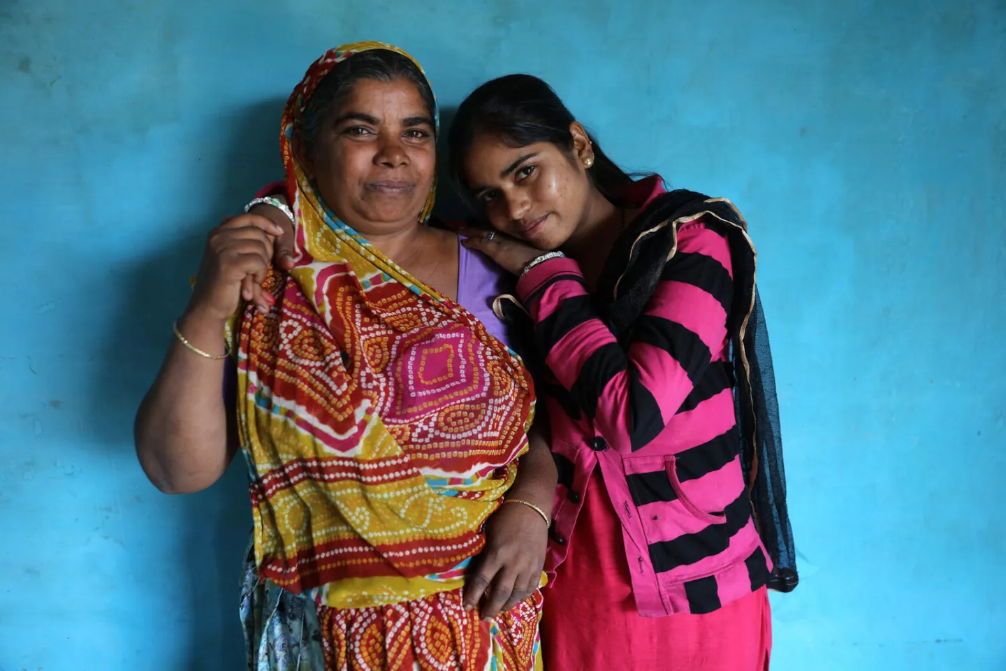 Tejal poses with her mother Puri in Village Santpur, India.
