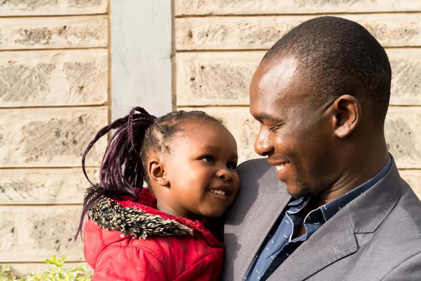Karen and her father Iddi Badi outside of the school building at the Little Rock Early Childhood Development Centre in Kibera, Nairobi, Kenya.