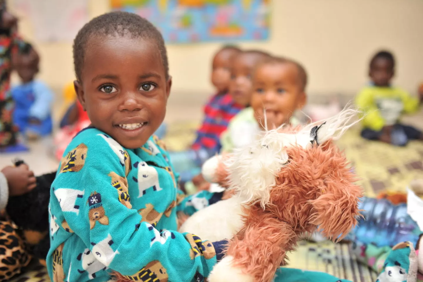 A young boy cuddles a teddy bear at the Rugerero Sector early childhood development centre in Rubavu, Rwanda.