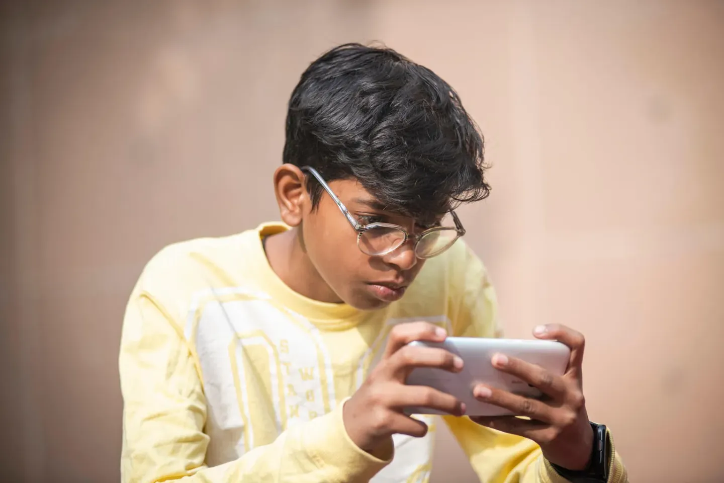 A teen uses his mobile phone in Delhi, India.