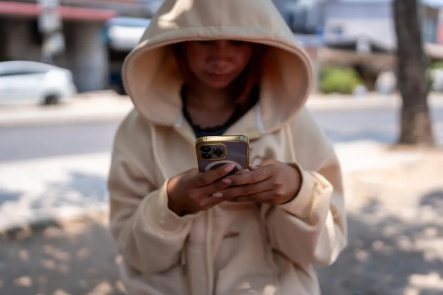 A teenager sits alone at a street restaurant in Siem Reap, Cambodia.