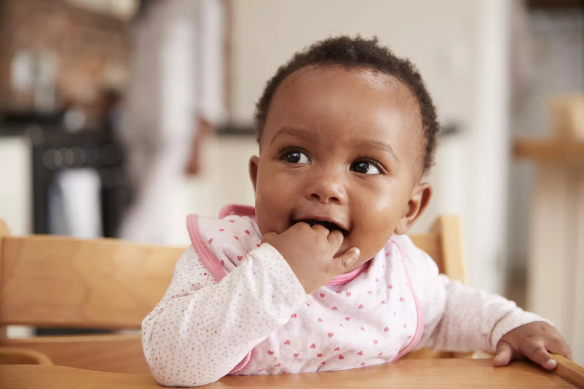 A baby girl shows signs of being hungry