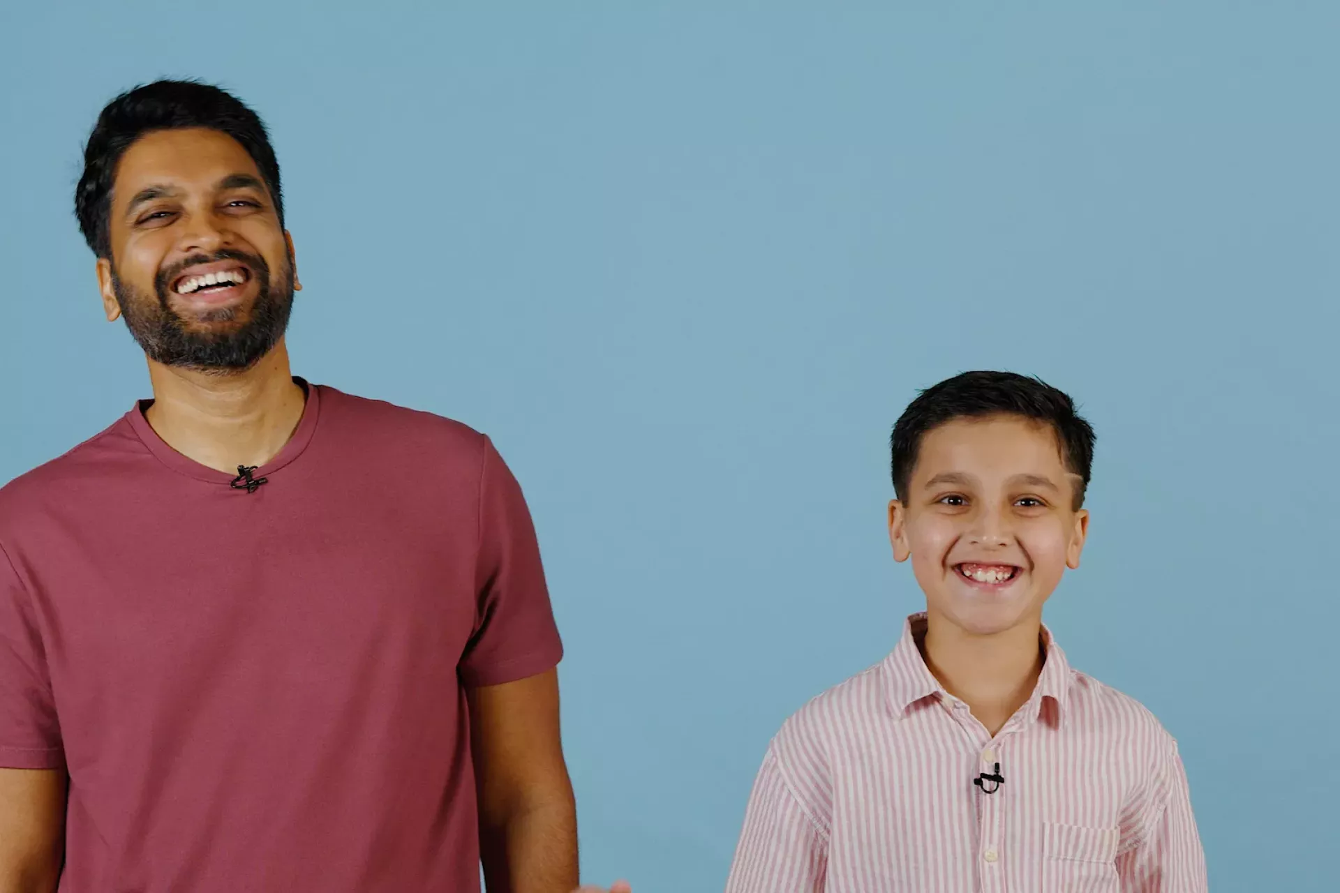 A father and son smile together