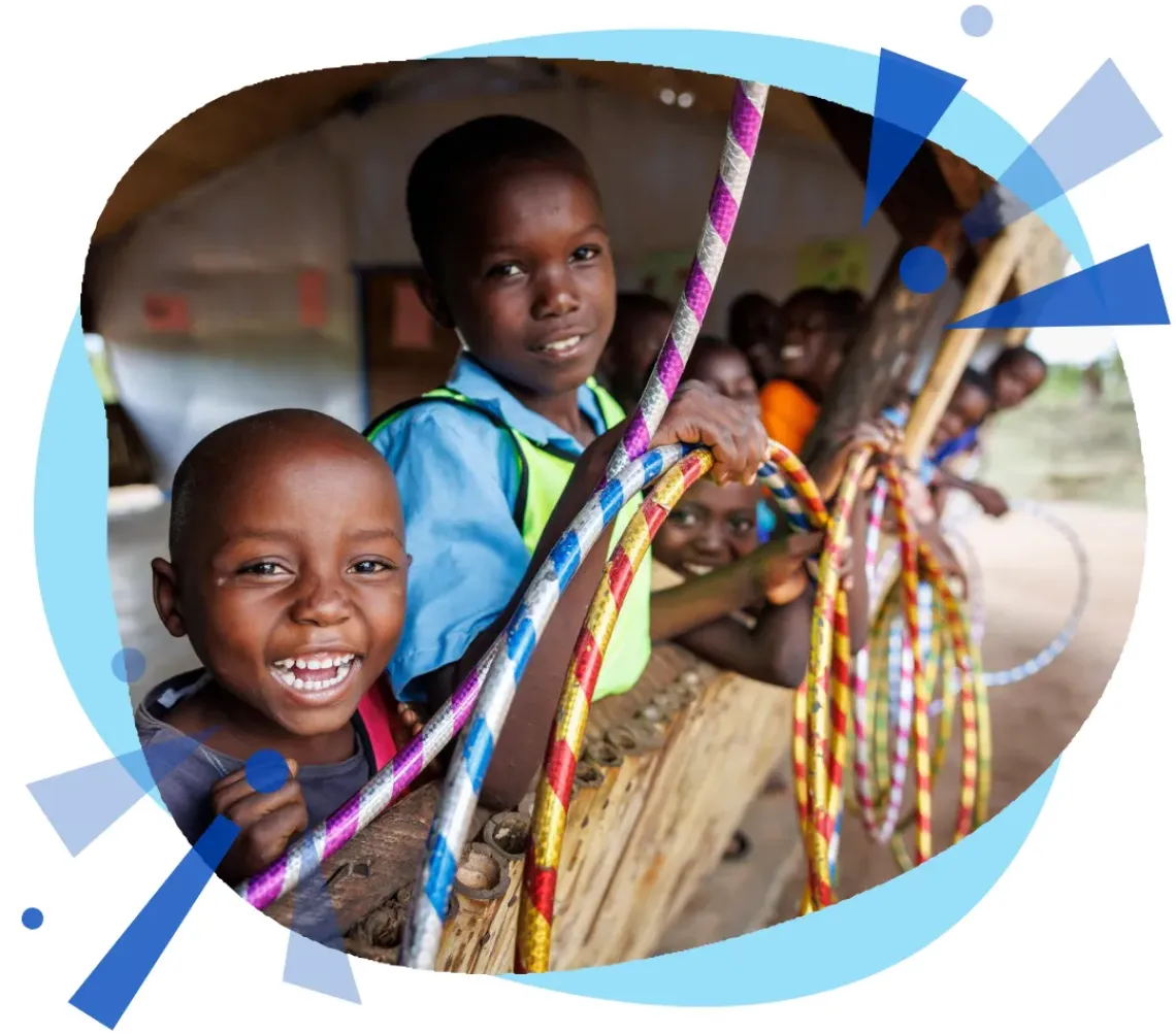 A group of boys in Mozambique play with hulahoops