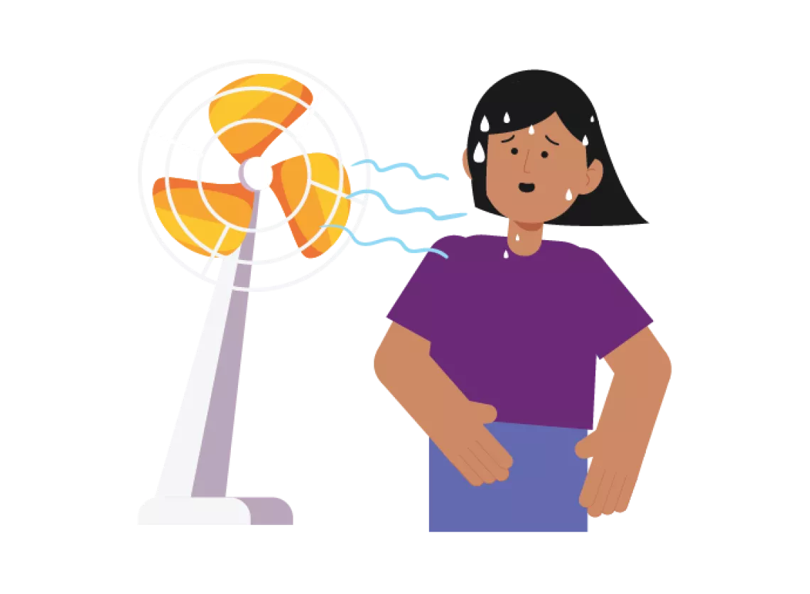 How to prepare for a heatwave: A girl stands next to a fan