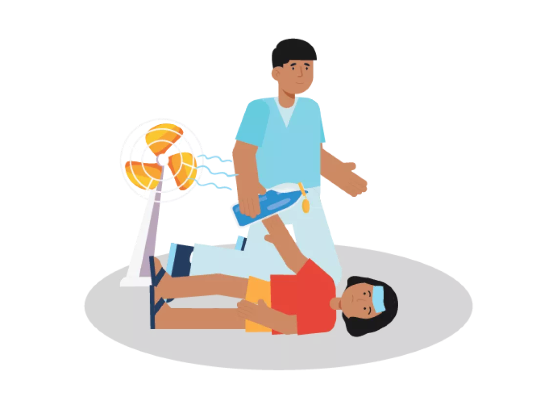 How to treat heat related illness: A girl lies on the floor while a caregiver provides water