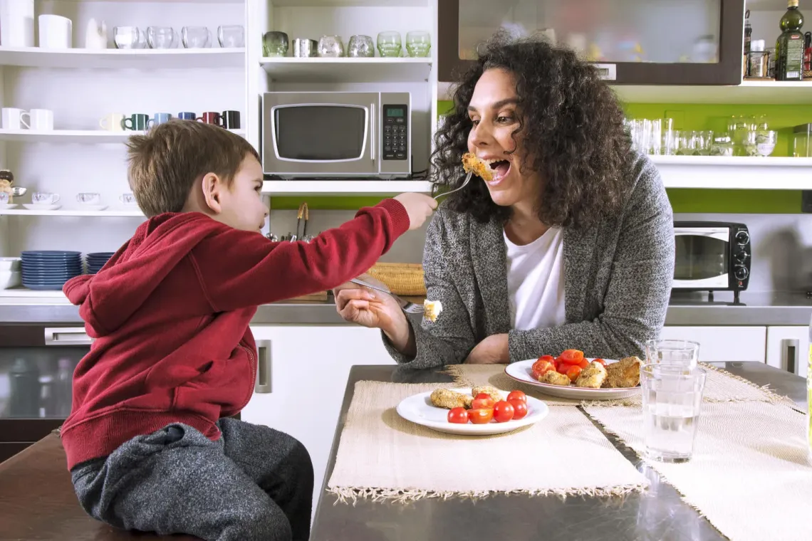 Mother and son eating a meal