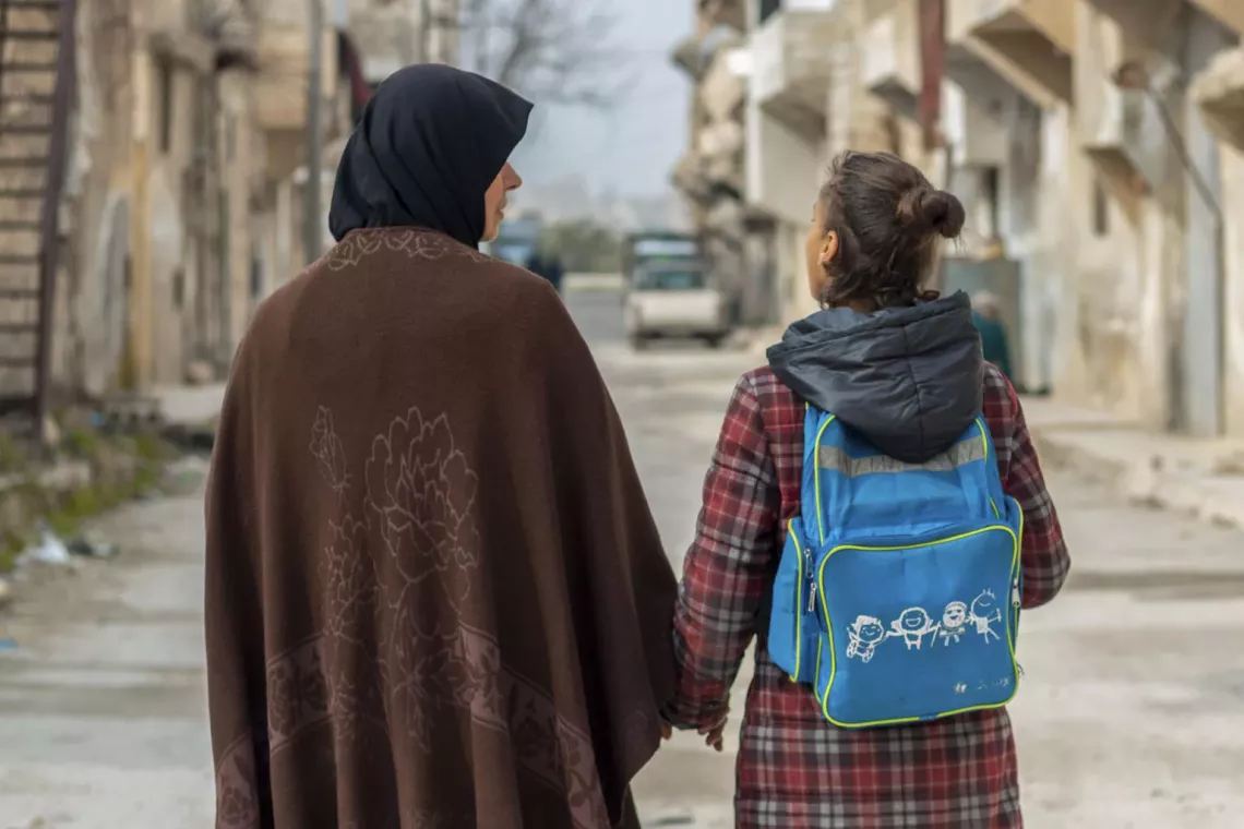 Fatima, 14, walks with her mother Ramia to school in Hanano neighbourhood, Aleppo city, northwest Syria.
