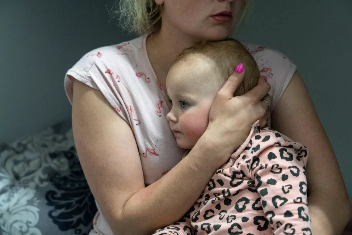 Une m&egrave;re tient son b&eacute;b&eacute; dans les bras