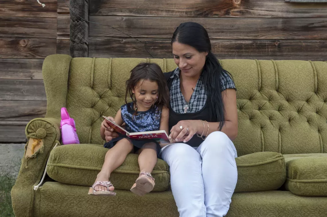 A mother and daughter read together in Serbia