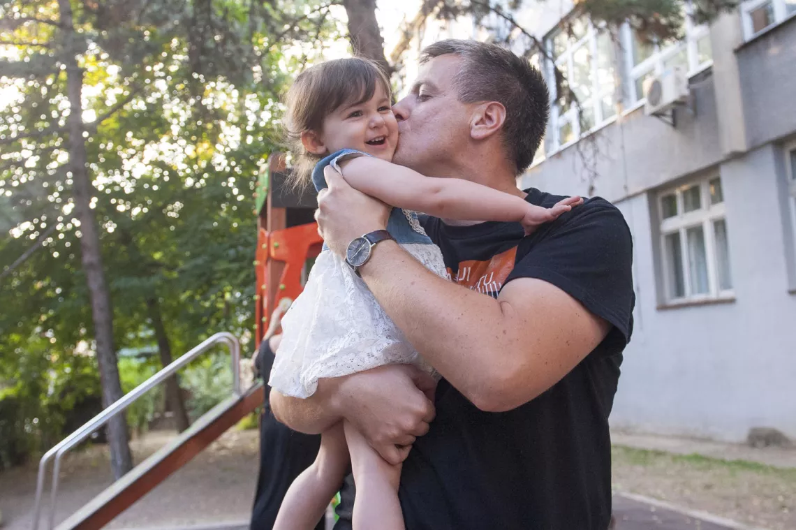 A father plays with his daughter in Serbia.