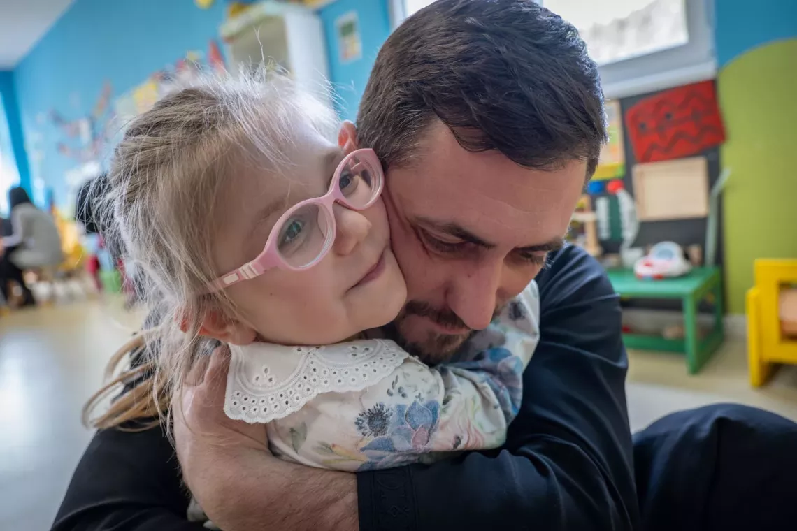 Parenting wisdom: A father hugs his daughter in Ukraine