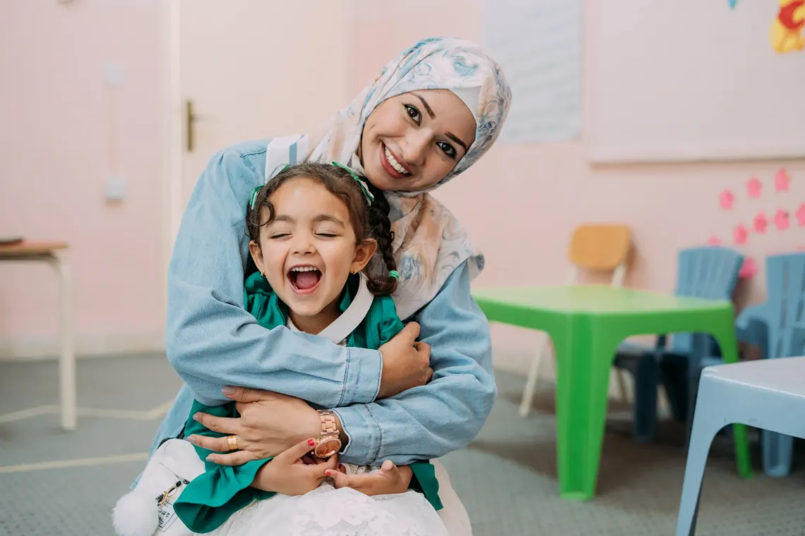 A mother and daughter having fun together at a parenting programme in Jordan