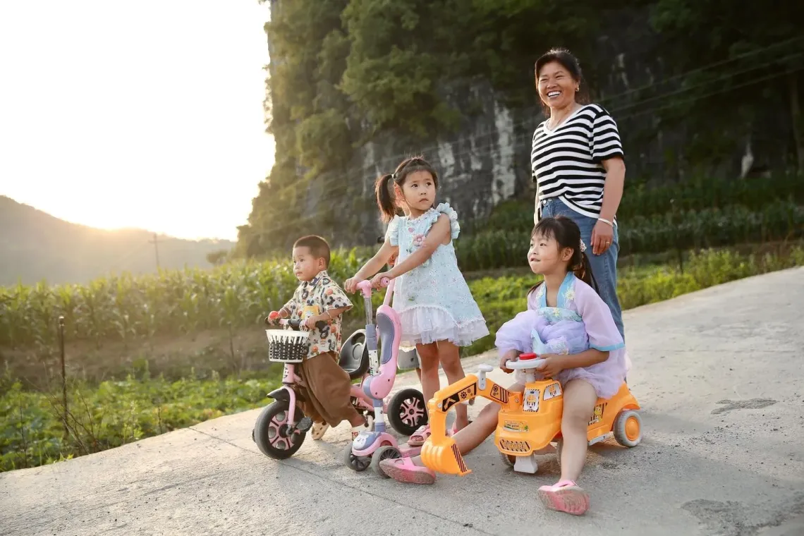 Zhang Qin watches over her grandchildren as they play in their village in Guizhou Province, China.