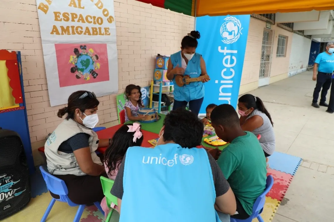 Children in a friendly space, playing games.