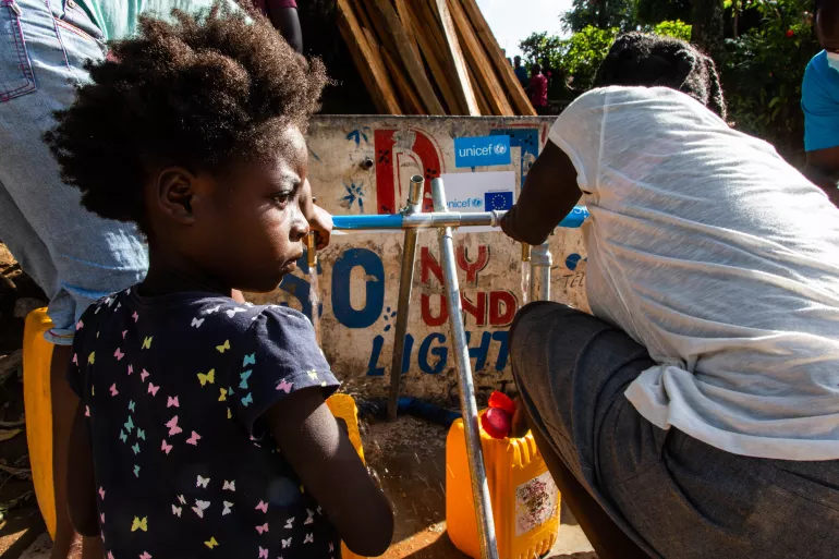 niños recolectando agua en haití
