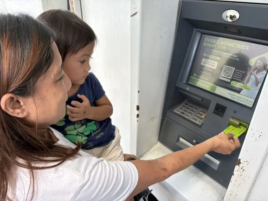Mother withdrawing cash