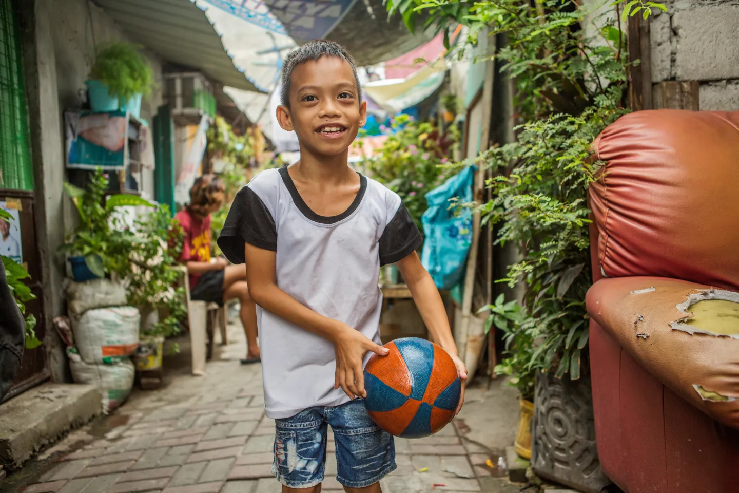 A child with a disability holding a ball