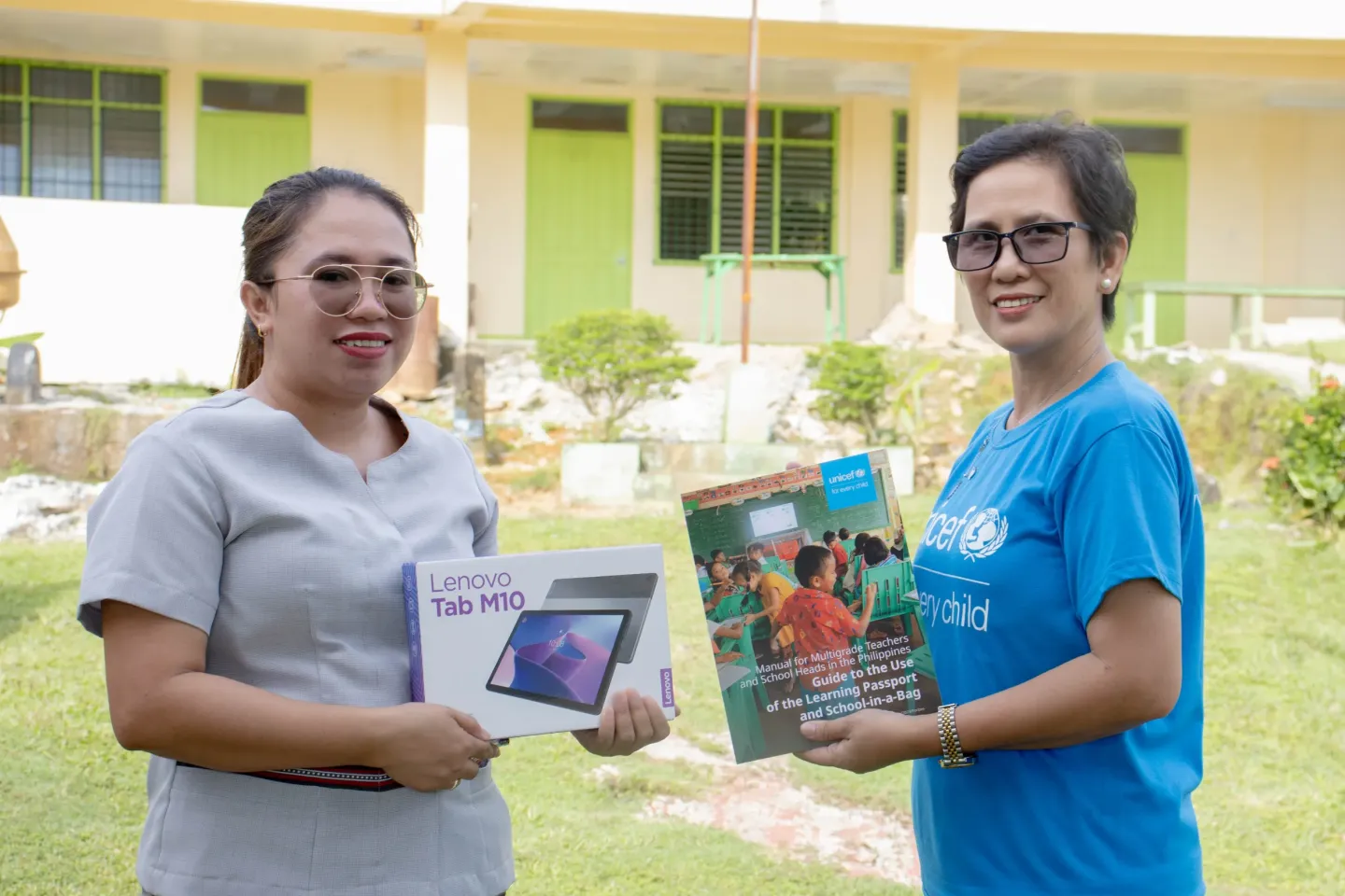 Teacher in the Philippines with UNICEF staff