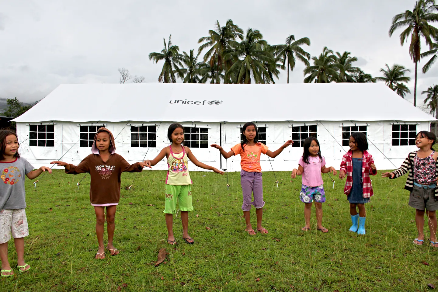Children playing in front of a UNICEF tent 