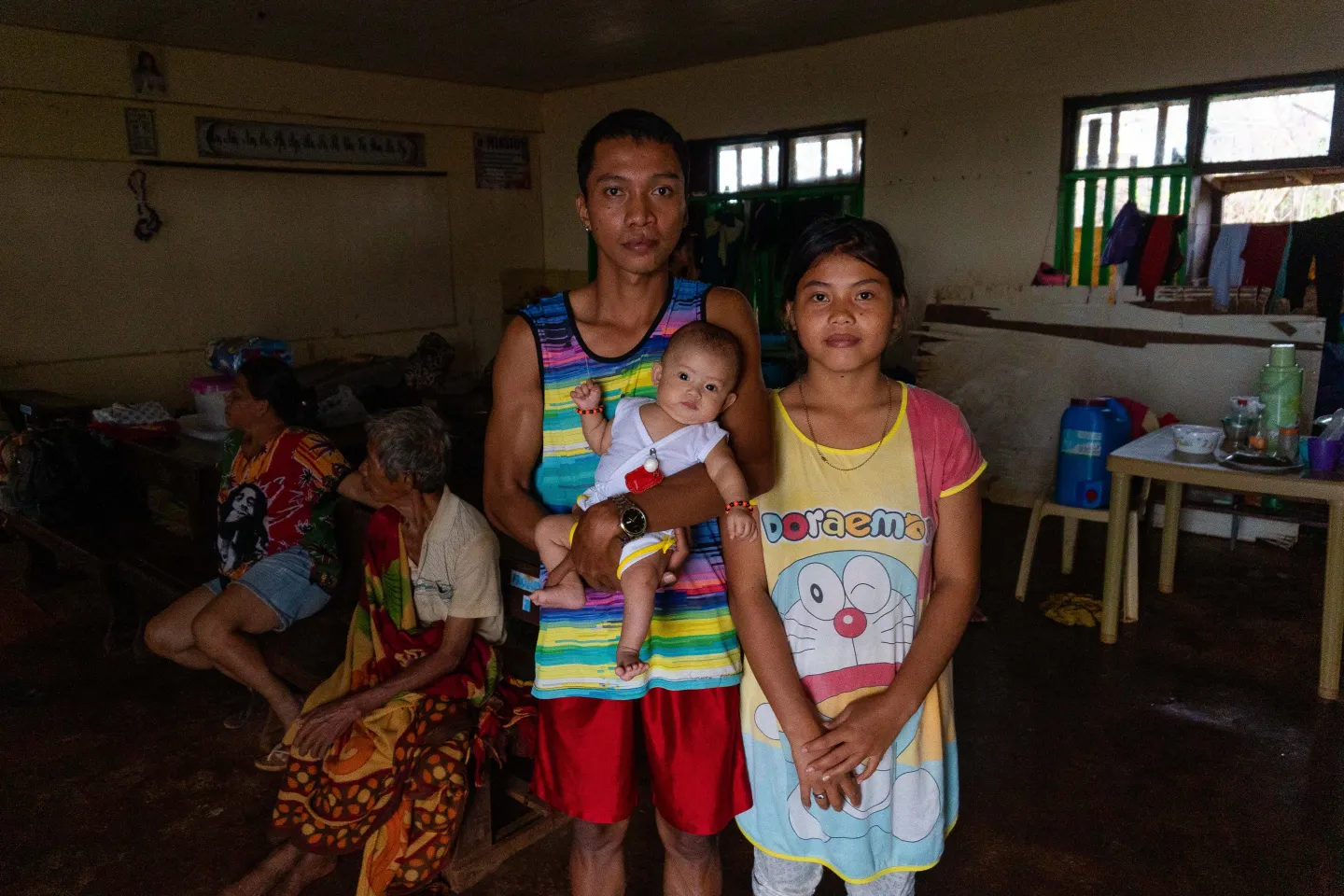 A family staying inside a classroom that is serving as an evacuation center