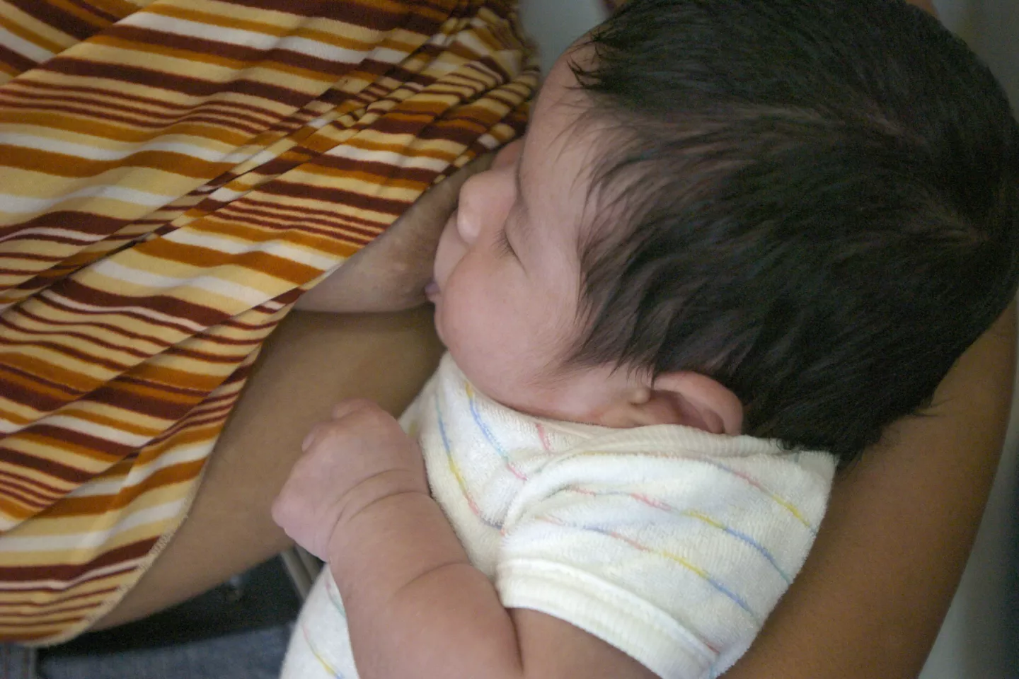 2004, a baby being breastfed in a health centre in the village of Amas, North Cotabato province, Mindanao region, Southern Philippines. UNICEF supports exclusive breastfeeding.