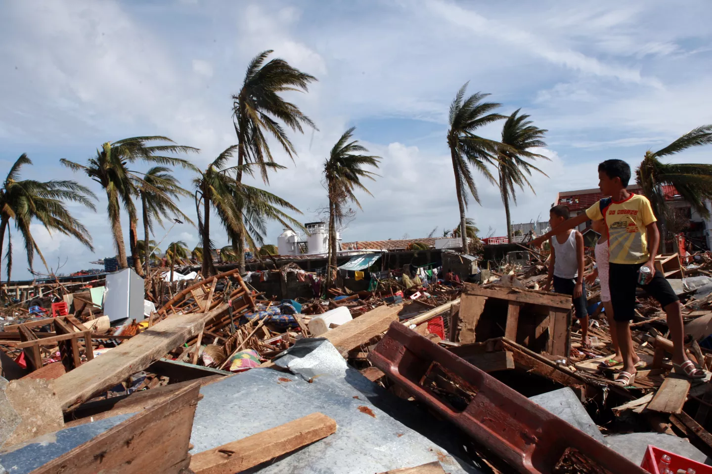 Two boys survey the damage in the aftermath of Typhoon Haiyan
