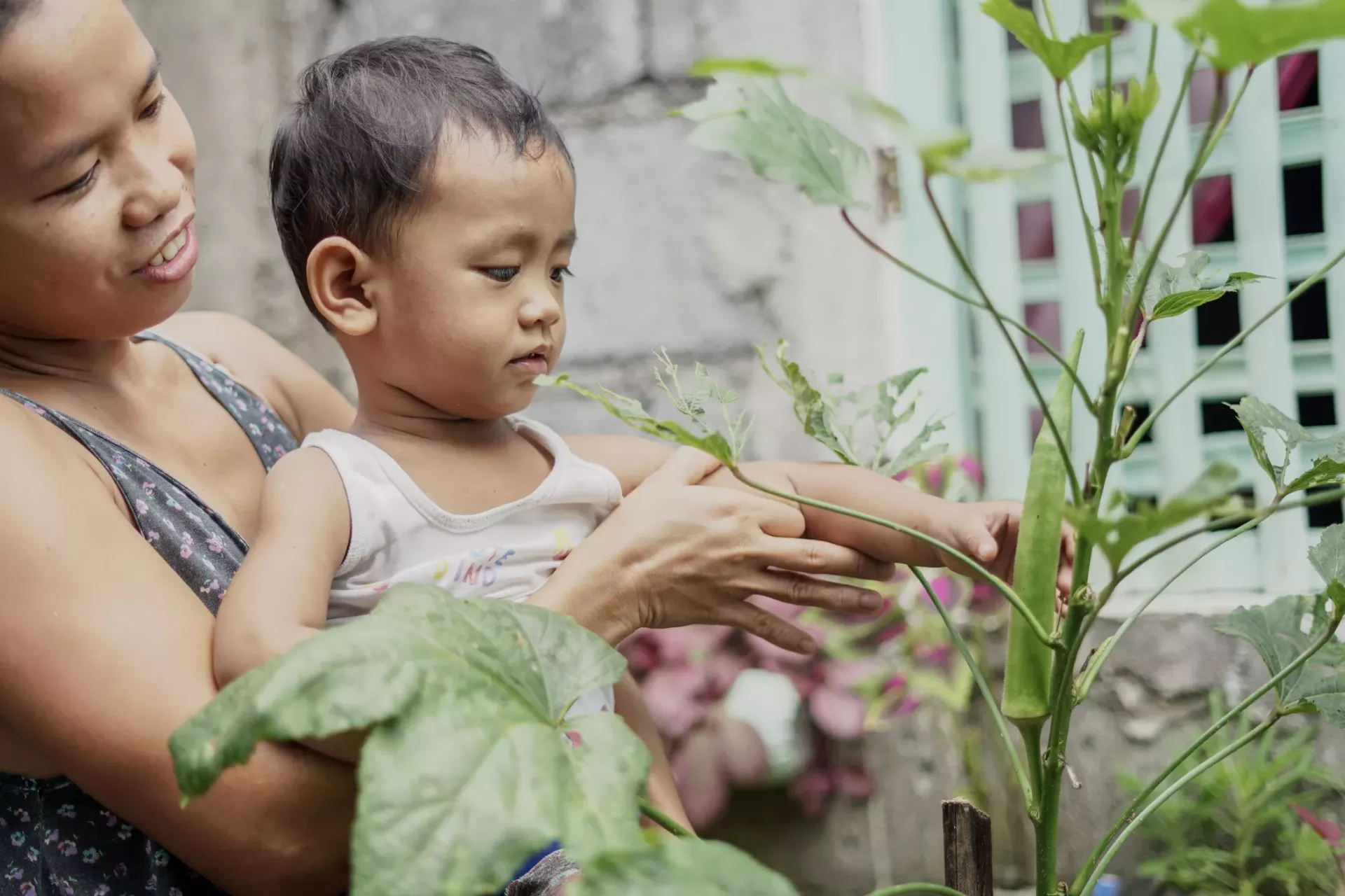 Mother and child in front of their mini-garden