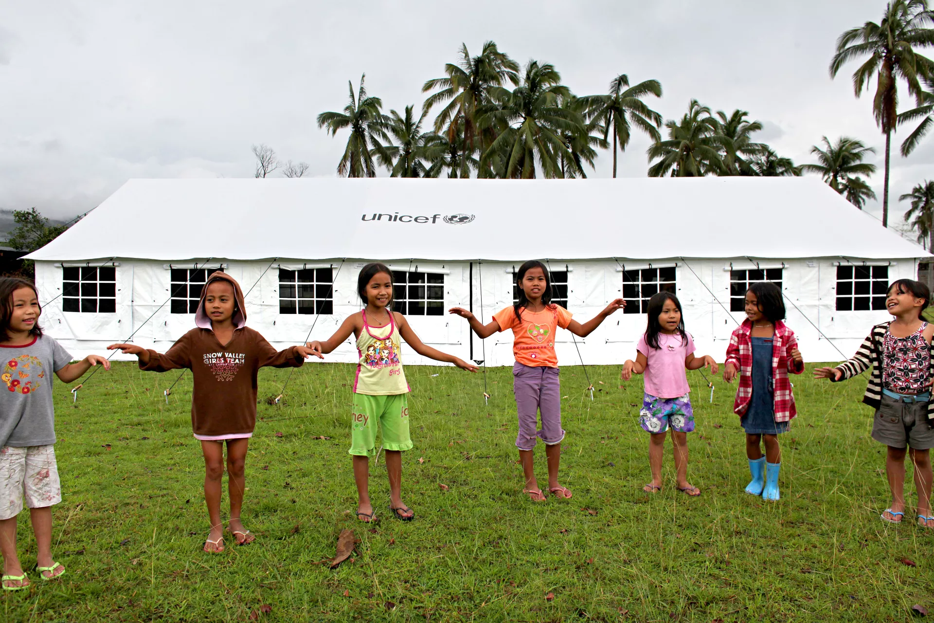 Children playing in front of a UNICEF tent 