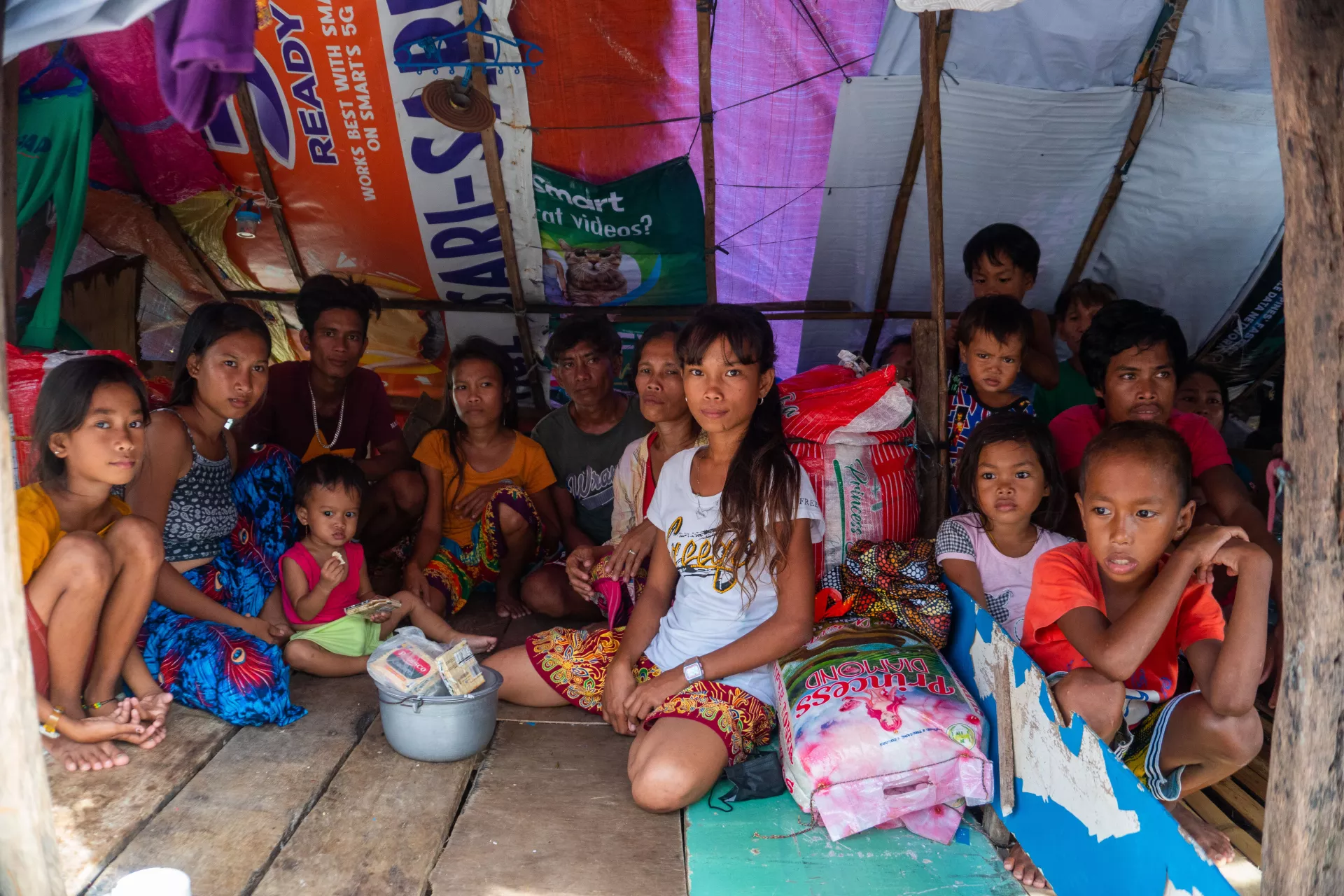A family sitting together inside their shanty home