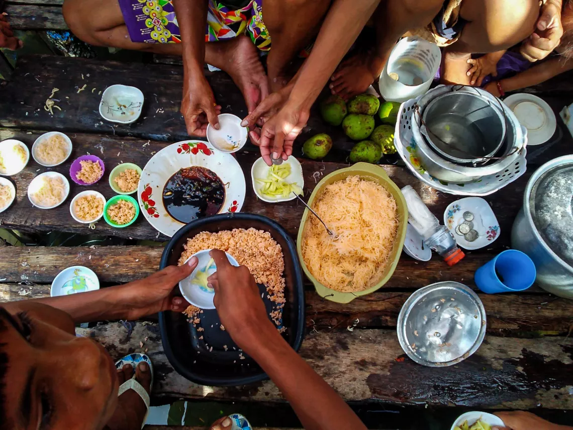 An overhead photo of a family preparing a meal