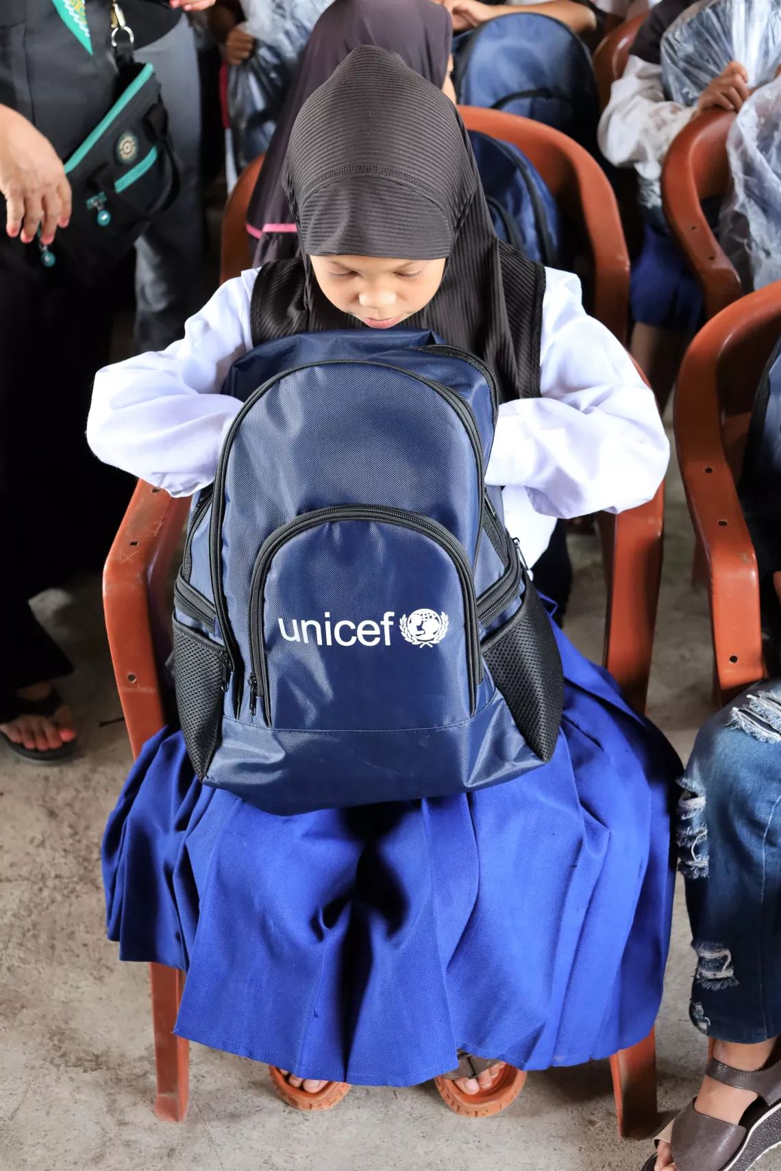 Girl and UNICEF bag