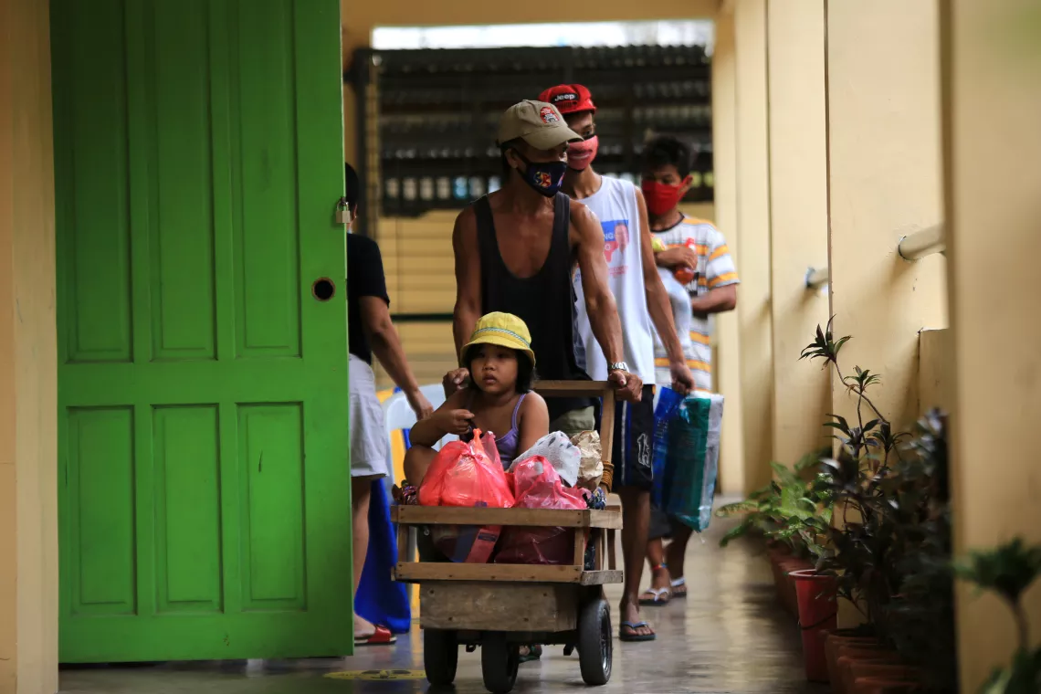 Residents arrive at an evacuation center in Legaspi, Albay province, on 31 October 2020 ahead of Rolly/Goni landfall.