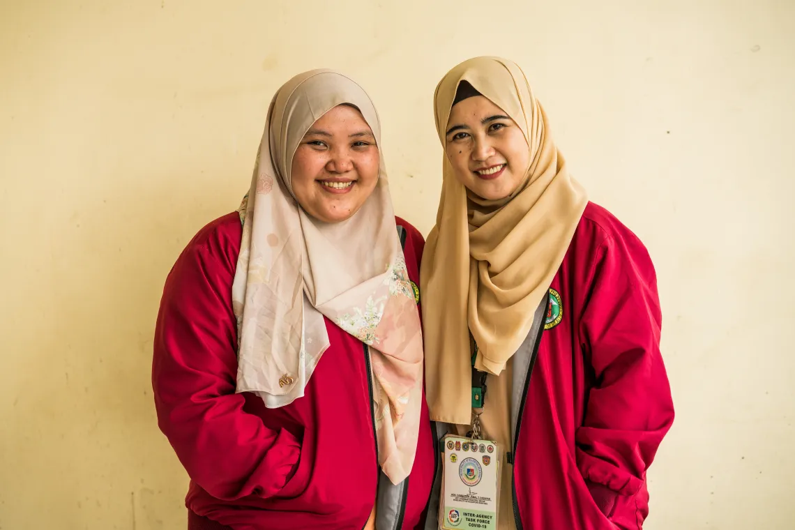 Health workers Ash (left), and Injilah (right), during a day at work.