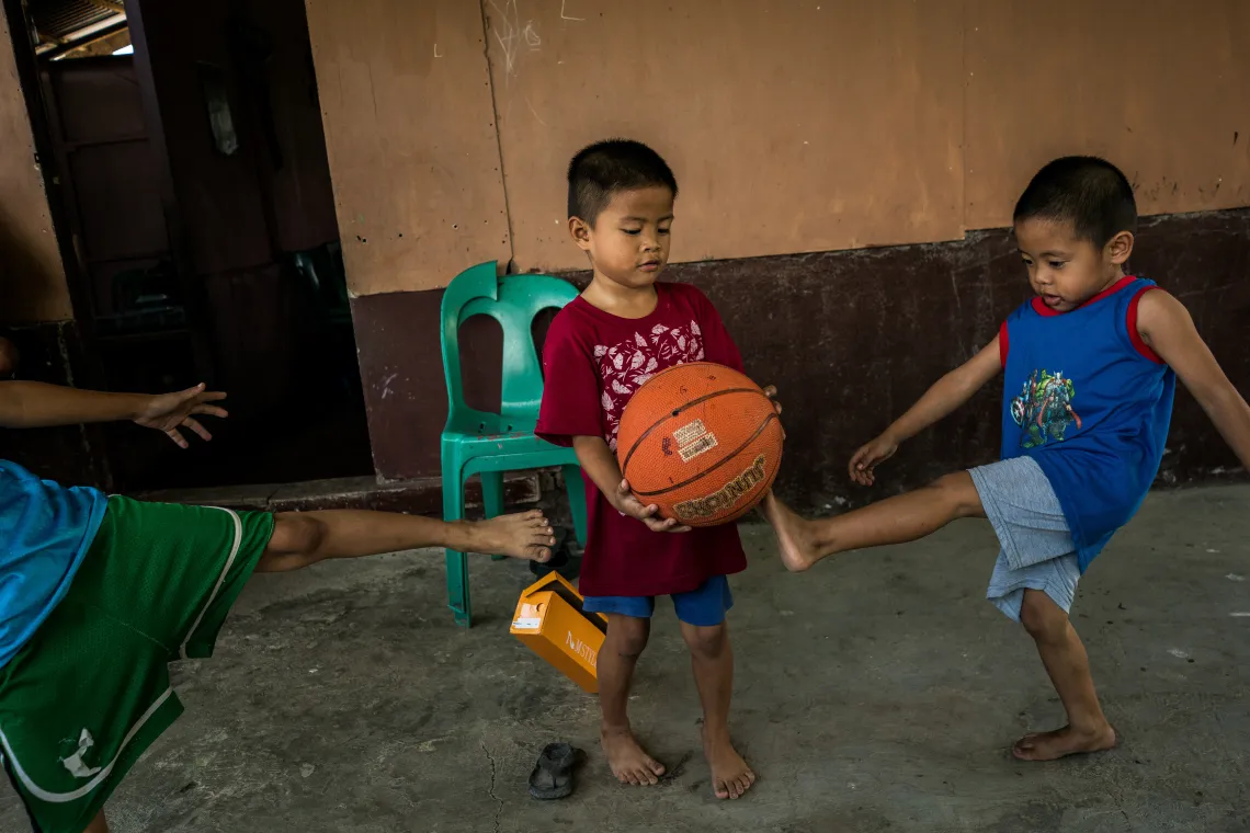 Alnur, 4, (right), plays at home with his brother, Saiben, 6, (left).