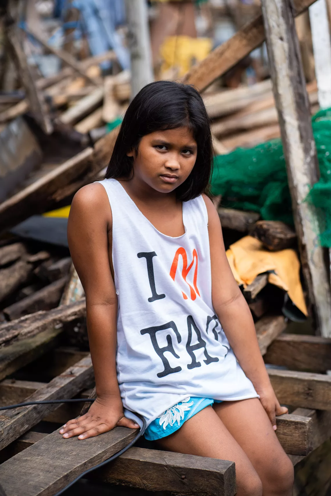 A girl sitting amid debris