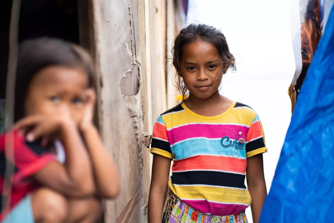 A girl standing among other children