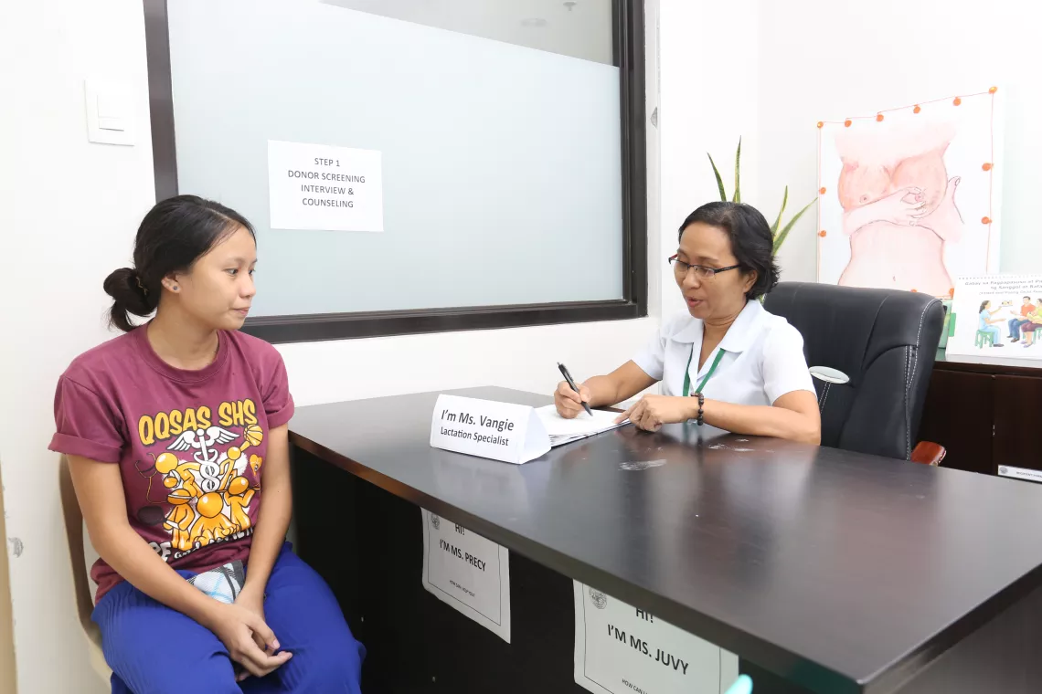 A nurse talks to a woman inside a human milk bank