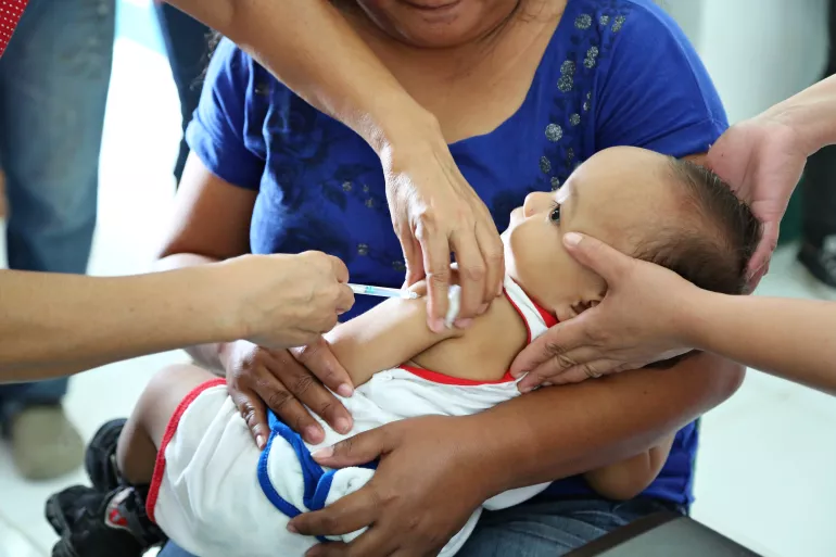 A child gets vaccinated at a health centre