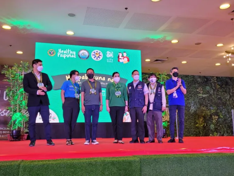 Officials standing together on a stage at an event launching the Chikiting Bakunation Days