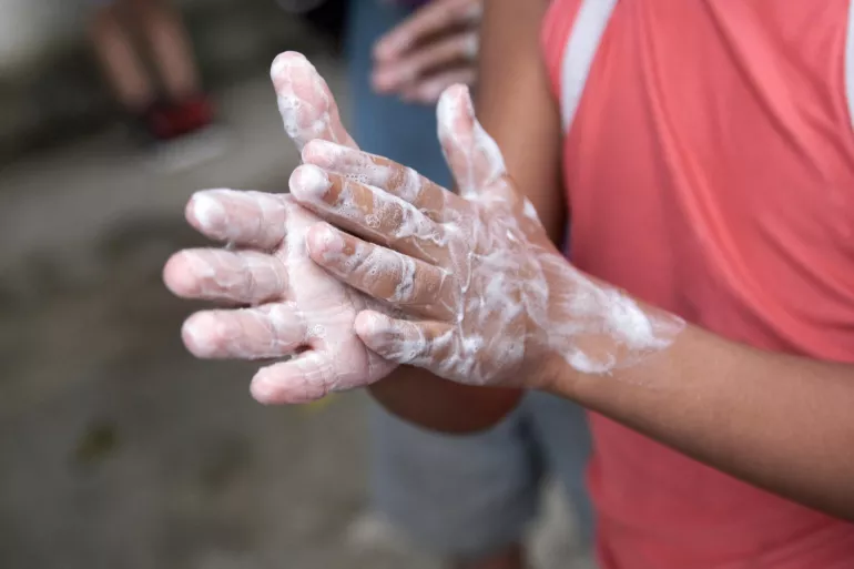 A child learns handwashing technique during an activity supported by UNICEF