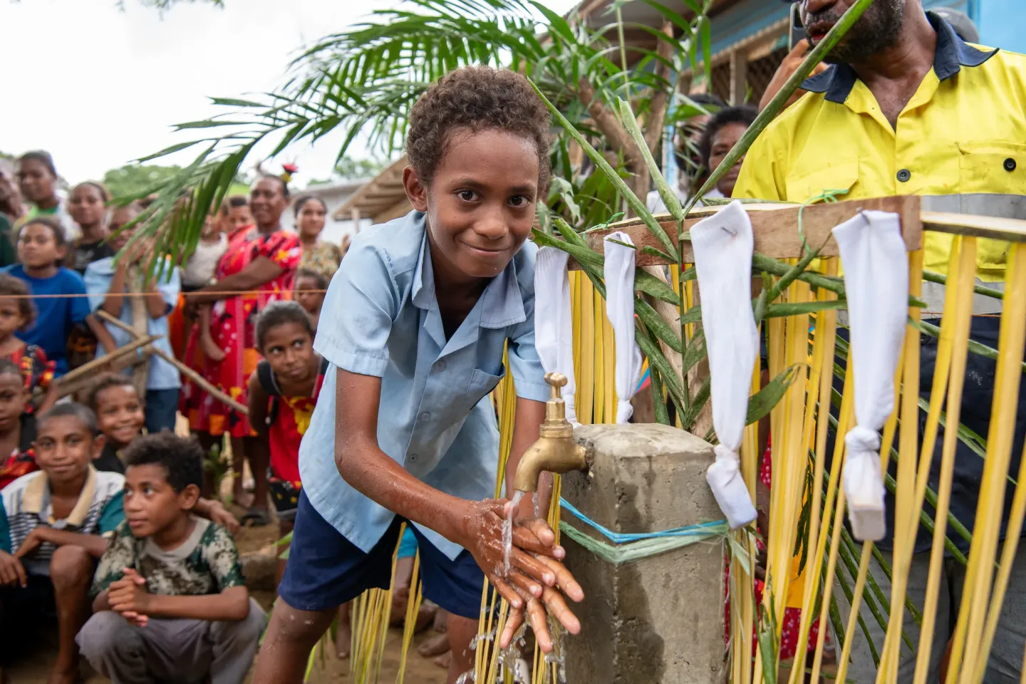 A young student washing his hand from a recently established water tap in Boregaina Village, Central Province. 