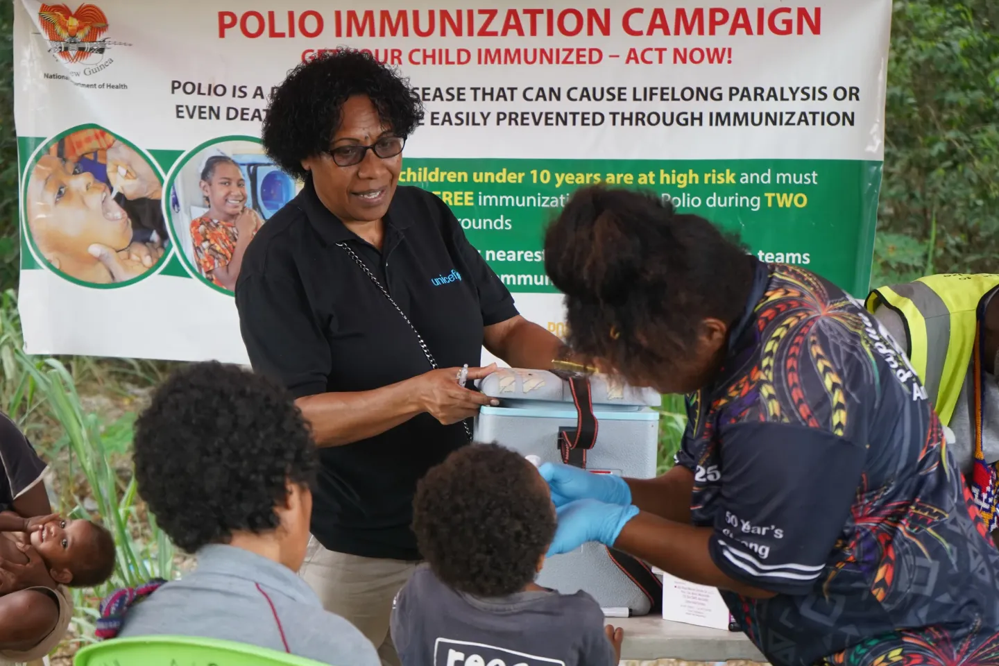 UNICEF polio monitoring team make a stop at the Kwikila junction booth to inspect how the immunization campaign is going. 