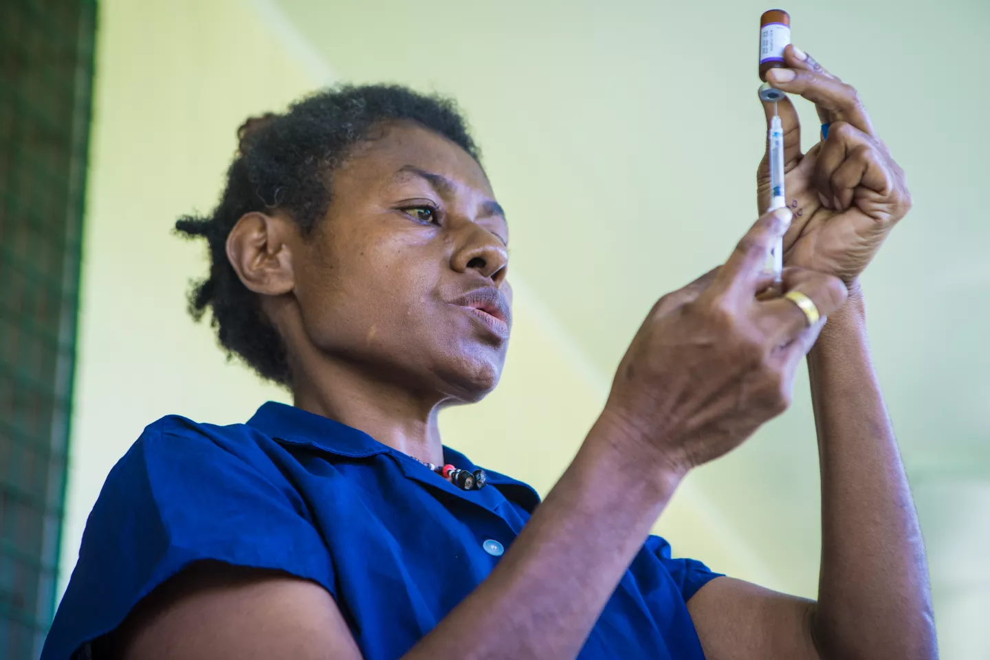 A nurse prepares the medicine to inject.