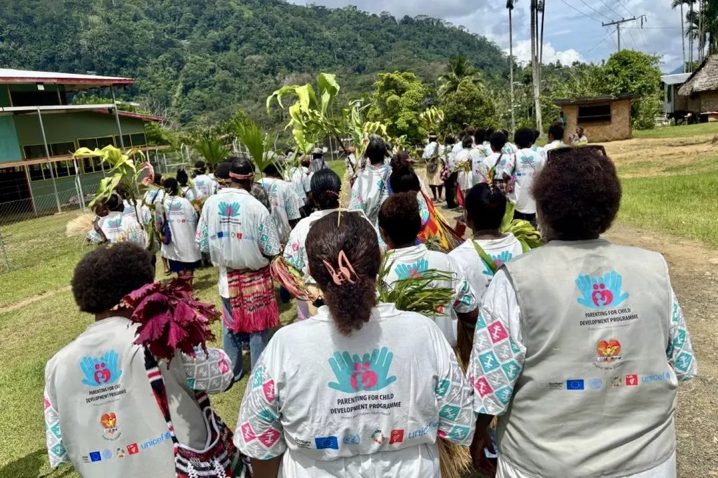 Stepping forward: participants make their way to a Parenting for Child Development session, bringing with them the hope of breaking the cycle of violence in their communities