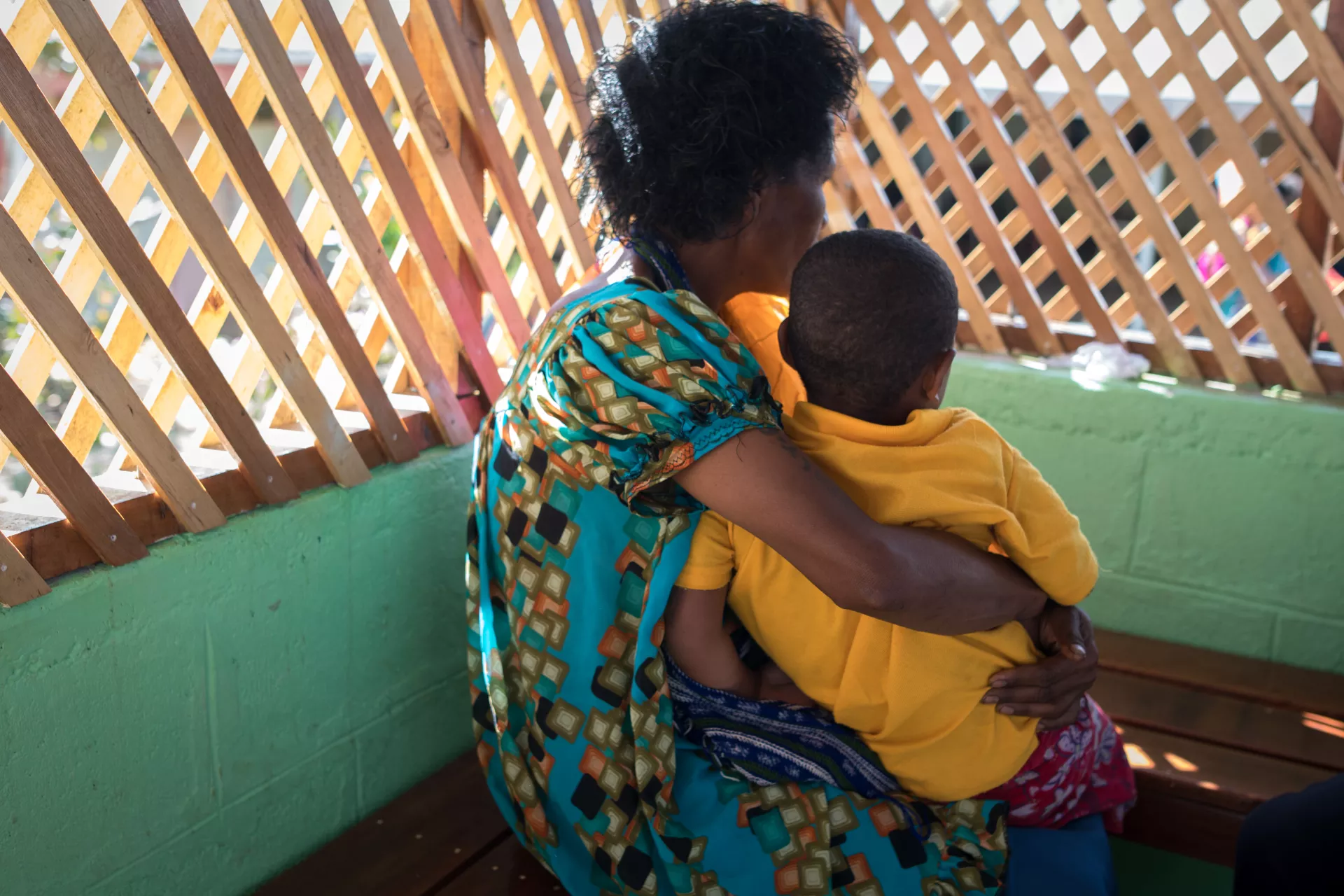 A mother and child waiting outside the Family Support Centre.