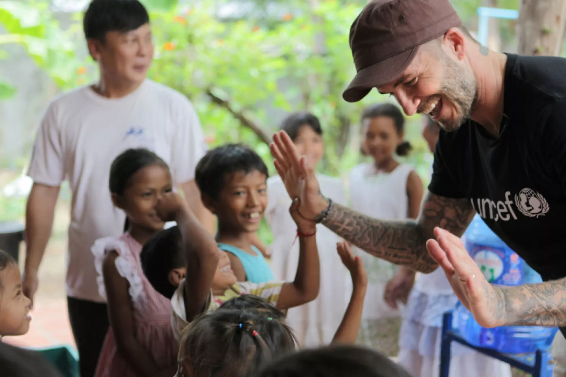David Beckham gives high-five to kids